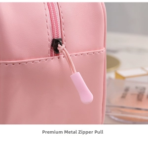 Detailed close-up of a pink waterproof cosmetic bag with a smooth metal zipper and PU leather