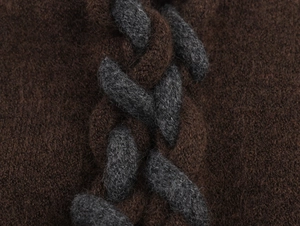 Vue macro d'un cardigan en maille tressée marron et gris avec texture douce et pelucheuse