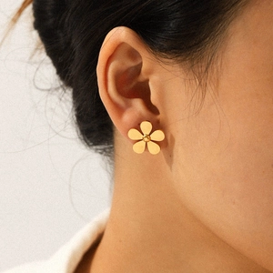 18k gold plated stainless steel five-petal daisy stud earrings on model's ear