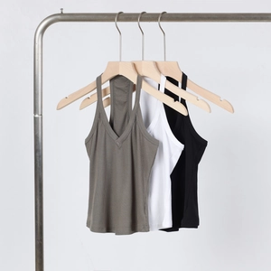Detail view of V-neck ribbed tanks in gray, white, and black on a rack