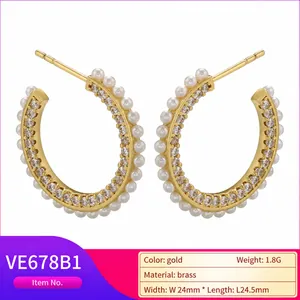 Gold C-shaped brass hoop earrings with micro-pave cubic zirconia and white pearls