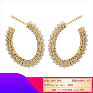 Gold C-shaped brass hoop earrings with micro-pave cubic zirconia and white pearls