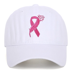 Close-up of pink ribbon and feather embroidery on a white cotton baseball cap