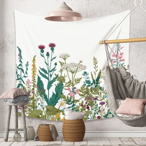 Detail of bohemian white tapestry featuring realistic wild flowers on a textured grey wall