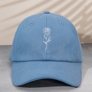 Close-up of white rose embroidery on high-quality light blue cotton baseball cap