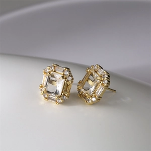 Detailed view of octagon-cut zircon earrings with gold plating and surrounding micro-pave stones