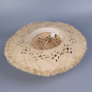 Natural raffia straw sun hat with wide brim, fringe edges, and hollow woven patterns