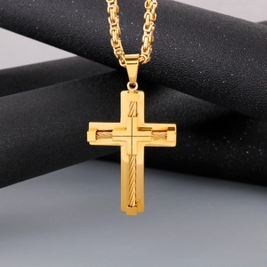 Detail of a golden cross pendant with twisted rope design on a Byzantine chain necklace