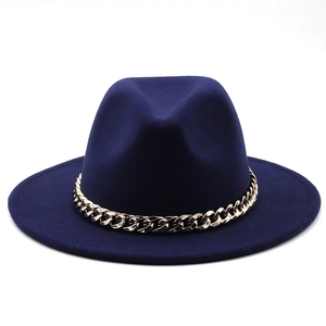 Close-up of a navy wool jazz fedora hat featuring a chunky gold metal chain detail