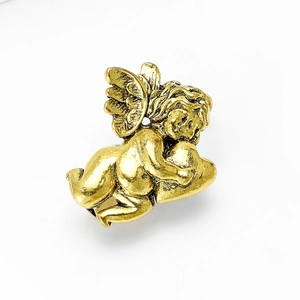 Macro shot of vintage gold alloy angel pin featuring a heart-hugging cherub design