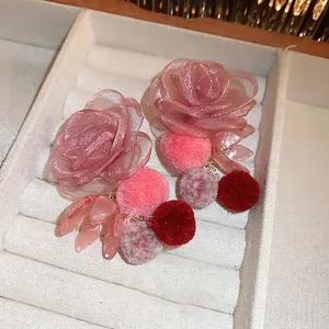 Handmade mesh flower earrings with pink pearls and soft pom-poms for sweet style