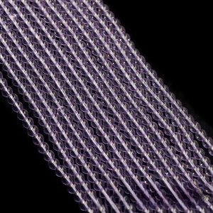 Macro view of translucent light purple round glass beads for DIY jewelry making crafts