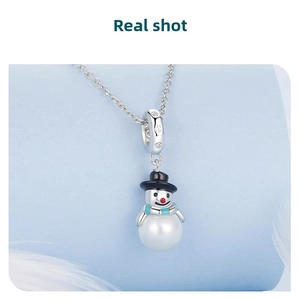 Detail of s925 silver snowman charm with pearl body, black hat, and teal scarf