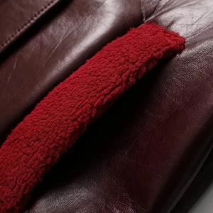 Detail of burgundy leather jacket with soft red fleece lining and sharp texture stitching