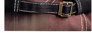 Detail view of the adjustable metal buckle and contrast stitching on a canvas baseball cap