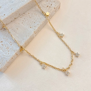 Gold stainless steel star and zircon flower necklace on a natural stone base