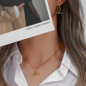 Fashionable gold stainless steel jewelry set featuring toggle bar necklace and earrings
