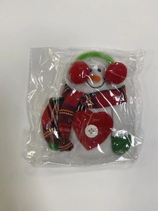 Detailed view of plush snowman cutlery holder for Christmas festive table settings