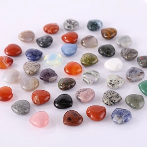 Polished heart-shaped natural gemstones including rose quartz and amethyst on white background
