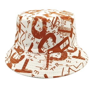 Detailed view of cream cotton bucket hat featuring red graffiti letter print and fine stitching