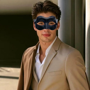 Detail shot of a matte black Zorro style masquerade mask for men worn with a tan suit