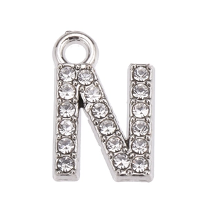 Close-up of silver letter N pendant with sparkling rhinestones and metal loop