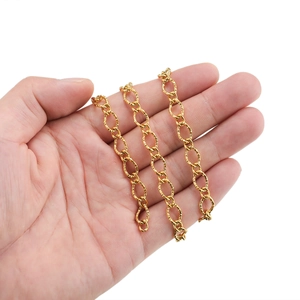 7mm gold plated stainless steel curb chain with embossed texture held in hand