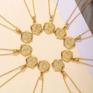 Gold plated hexagon initial letter necklaces featuring radial patterns from A to J