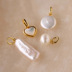 Set of four gold-plated stainless steel heart and baroque pearl jewelry pendant charms