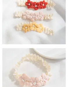 Detail of baby lace flower headbands with faux pearls in red, pink, and yellow