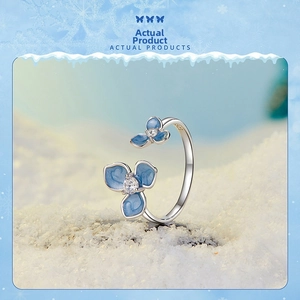 Macro shot of S925 sterling silver ring with blue enamel flowers and zircon centers