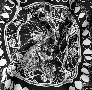 Macro shot of skull and moon phase patterns on soft black and white textile fabric