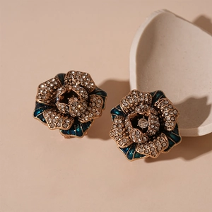 Vintage rose stud earrings with blue enamel petals and sparkling crystals in retro bronze