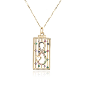 Macro detail of 18K gold plated necklace with infinity symbol and heart shaped pendant