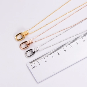 Three-color double ring pendant necklaces shown with a ruler for size measurement
