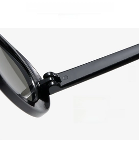Detail of sturdy metal hinge on black oval sunglasses for smooth opening and closing