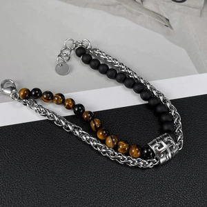 Detail of double-layer stainless steel bracelet with black matte beads and tiger eye stones
