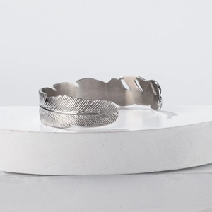 Adjustable silver feather cuff bracelet in vintage stainless steel with detailed texture