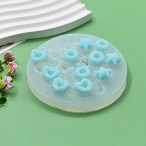 Detail of round silicone mold with star and heart shapes for resin and candle making