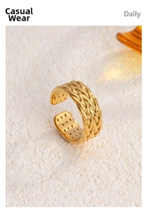 Detail of 18K gold-plated woven texture open ring showing intricate inner circular punch holes