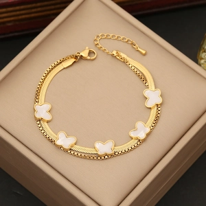 Double-layered gold butterfly necklace for women on a beige jewelry display box