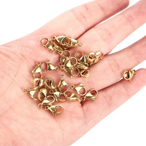 Golden stainless steel lobster clasps for DIY jewelry held in hand to show size