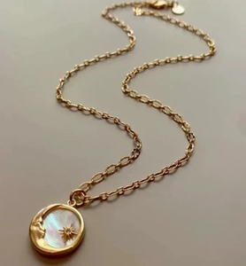 Detail of 18K gold stainless steel moon necklace with mother of pearl and star coin pendant