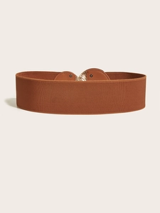 Detail of brown wide elastic waist belt with gold metal buckle and leather patchwork