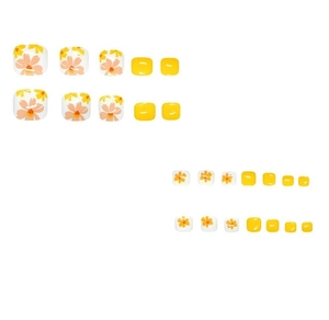 Detail of short square false toenails featuring yellow floral designs and bright yellow finish