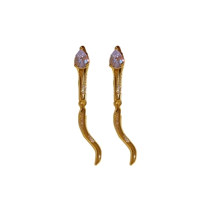 Elegant gold snake earrings with teardrop zircon and pavé crystals on white background