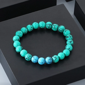 Detail shot of 8mm turquoise beaded bracelet with black veins on matte black base