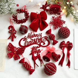 Red flocked Christmas ornaments set featuring elk, bells and snowflakes on plush background