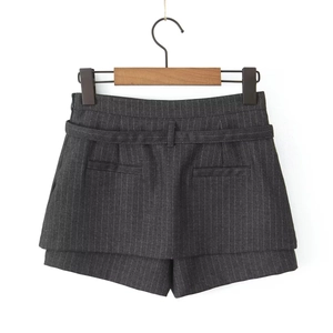 Detailed texture of dark grey pinstripe skort with fabric weave and pocket details