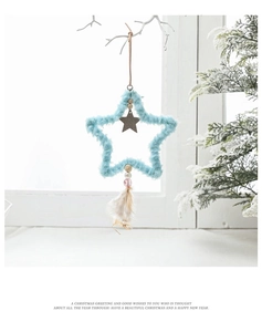 Blue fabric star ornament with plush trim, wooden center, and feathers for Christmas tree